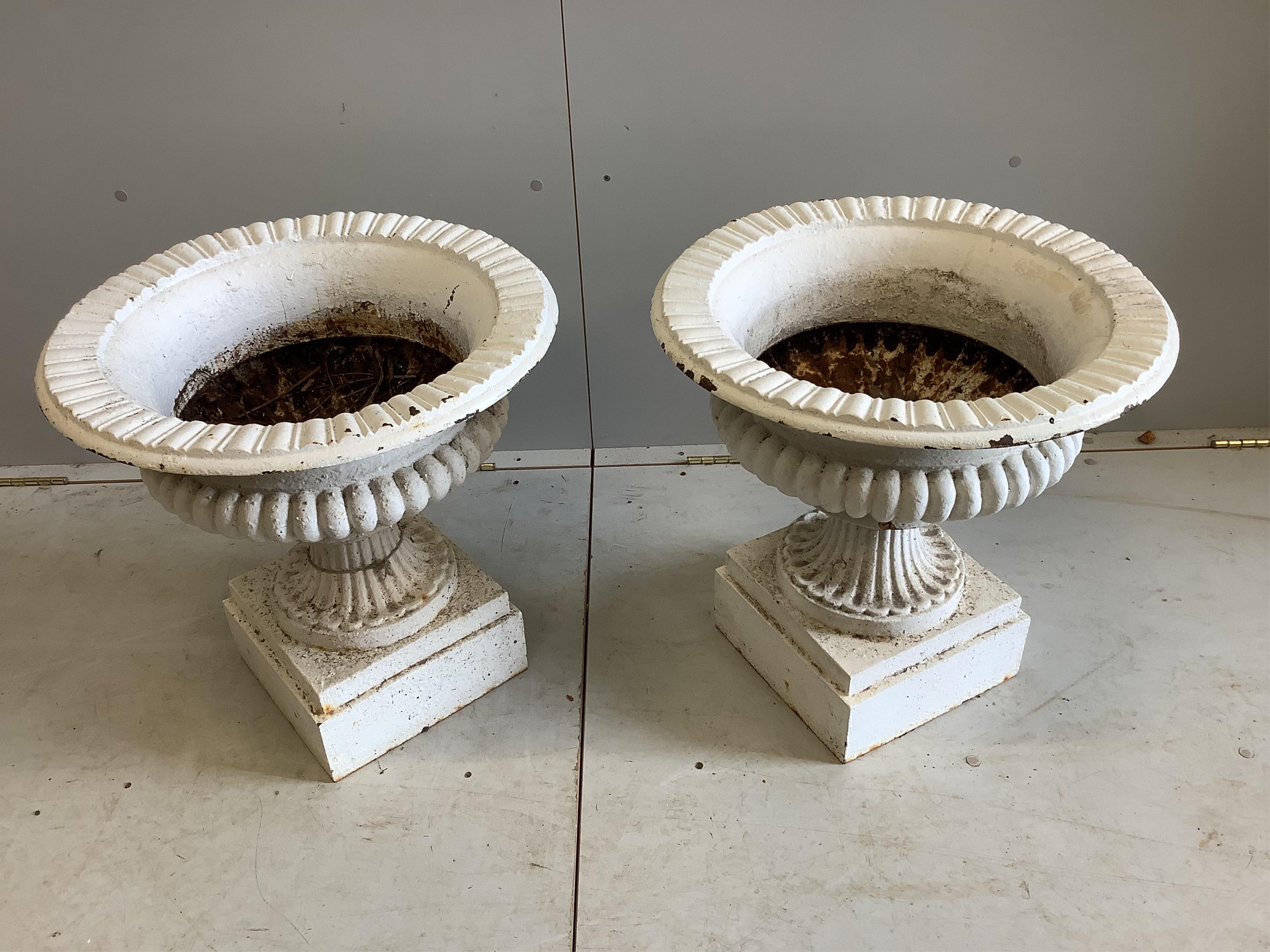 A pair of Victorian painted cast iron campana garden urns, diameter 52cm, height 51cm. Condition - fair